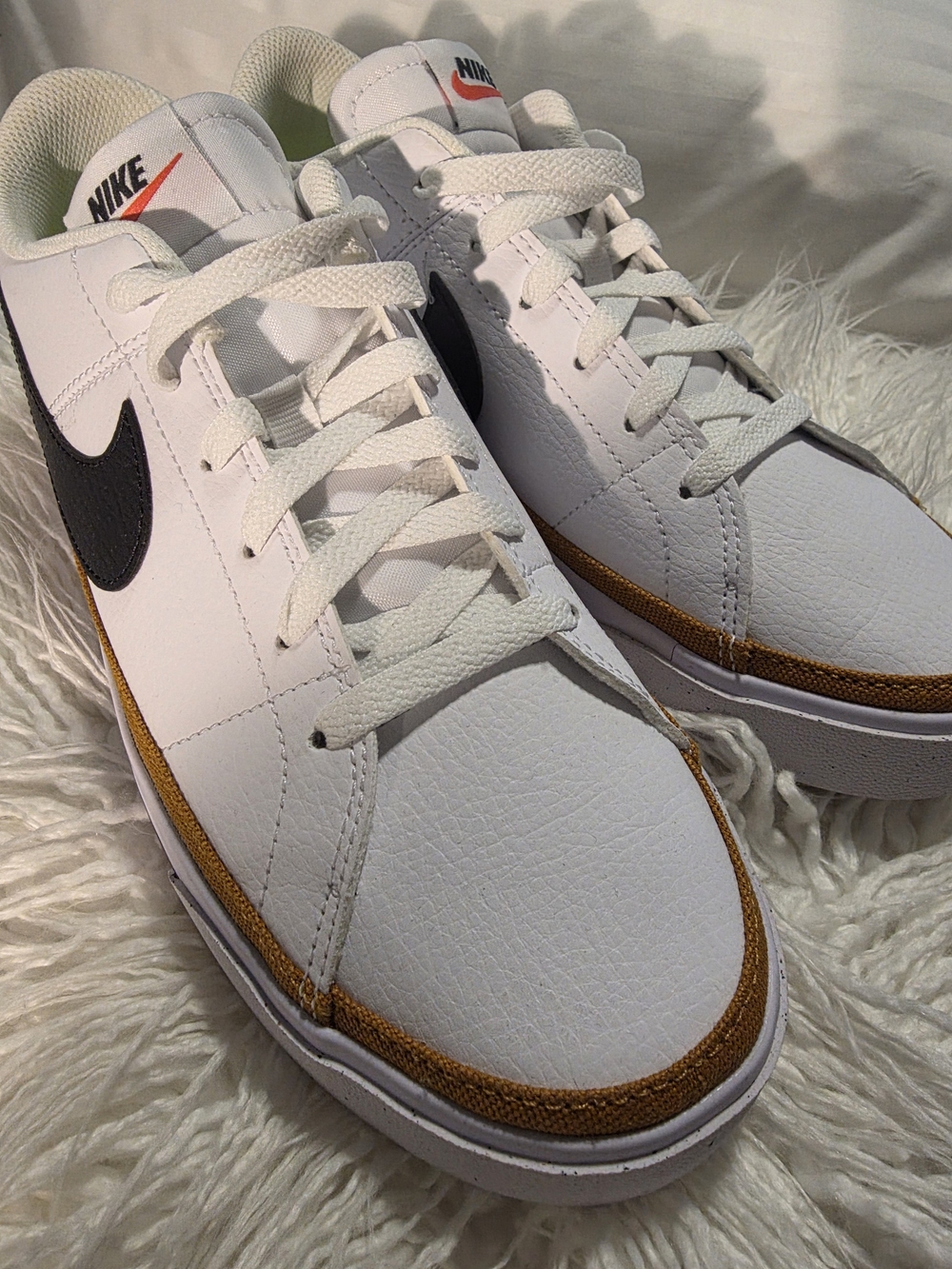 Nike Women’s White Leather Sneakers with Black Swoosh and Gold Trim